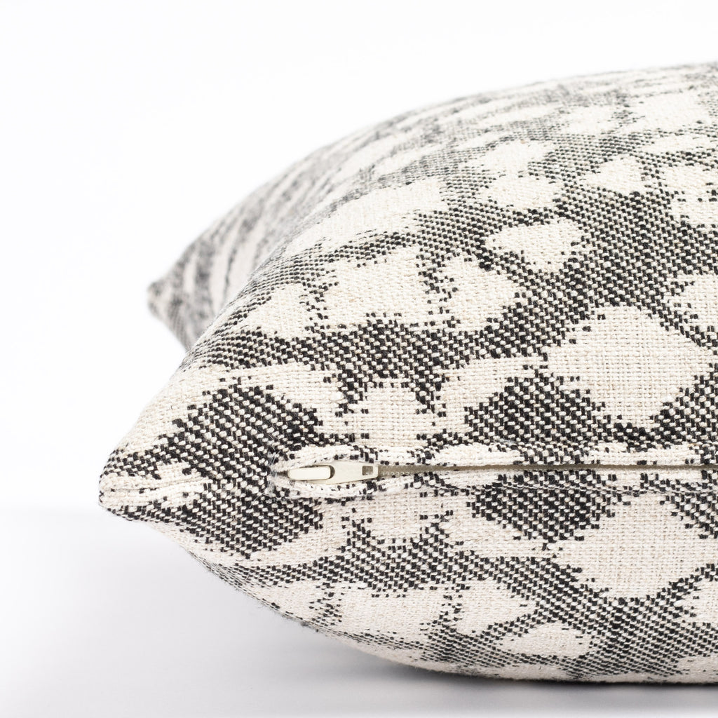 an abstract botanical patterned throw pillow : close up zipper detail
