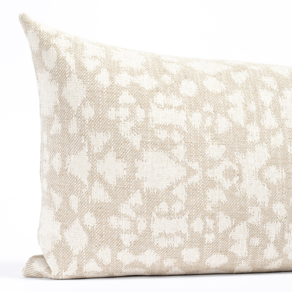a beige and cream abstract floral patterned lumbar throw pillow : close up view