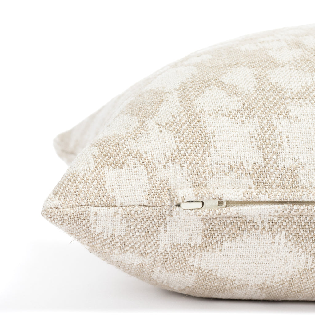 a beige and cream abstract floral patterned lumbar throw pillow : close up zipper detail