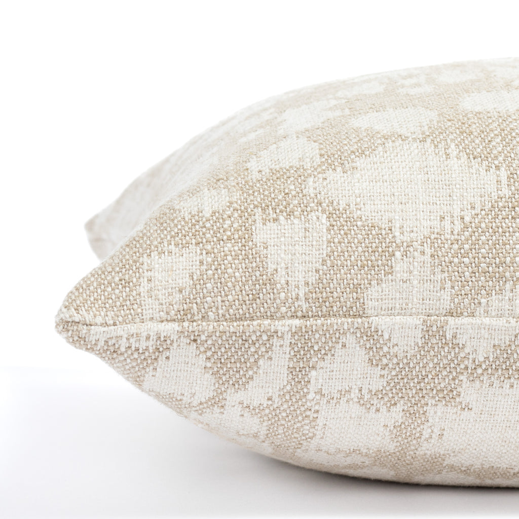 a beige and cream abstract floral patterned lumbar throw pillow : close up side view