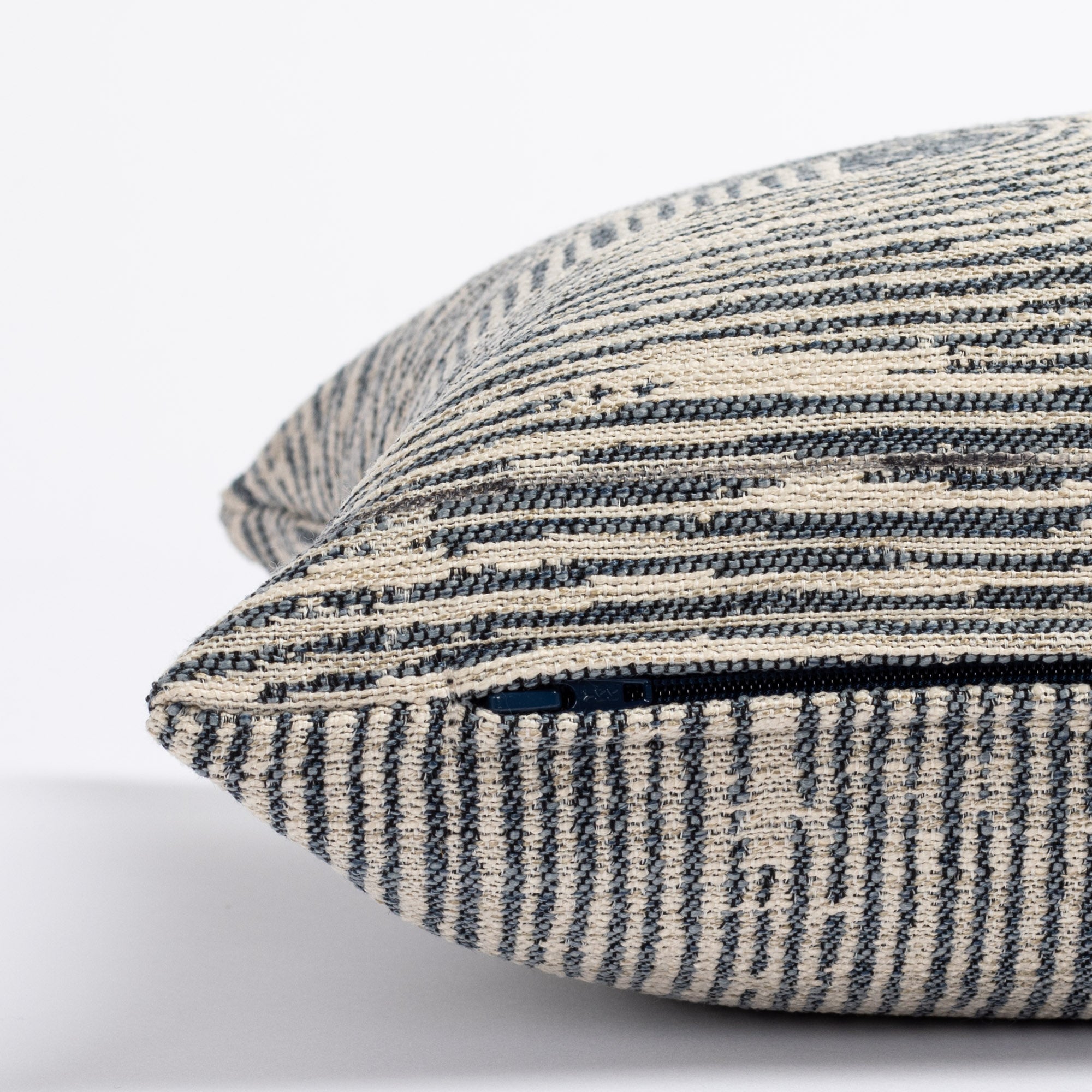 a indigo blue and grey patterned lumbar pillow : side zipper detail