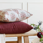 Stacked Tonic Living pillows: Bedford Merlot burgundy pillow with Grace Rosewood paisley pillow styled on a bench.