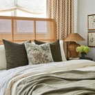 Tonic Living Bedford moss green throw pillow styled on bed with Manor Tapestry cushion, earthy layered bedroom look