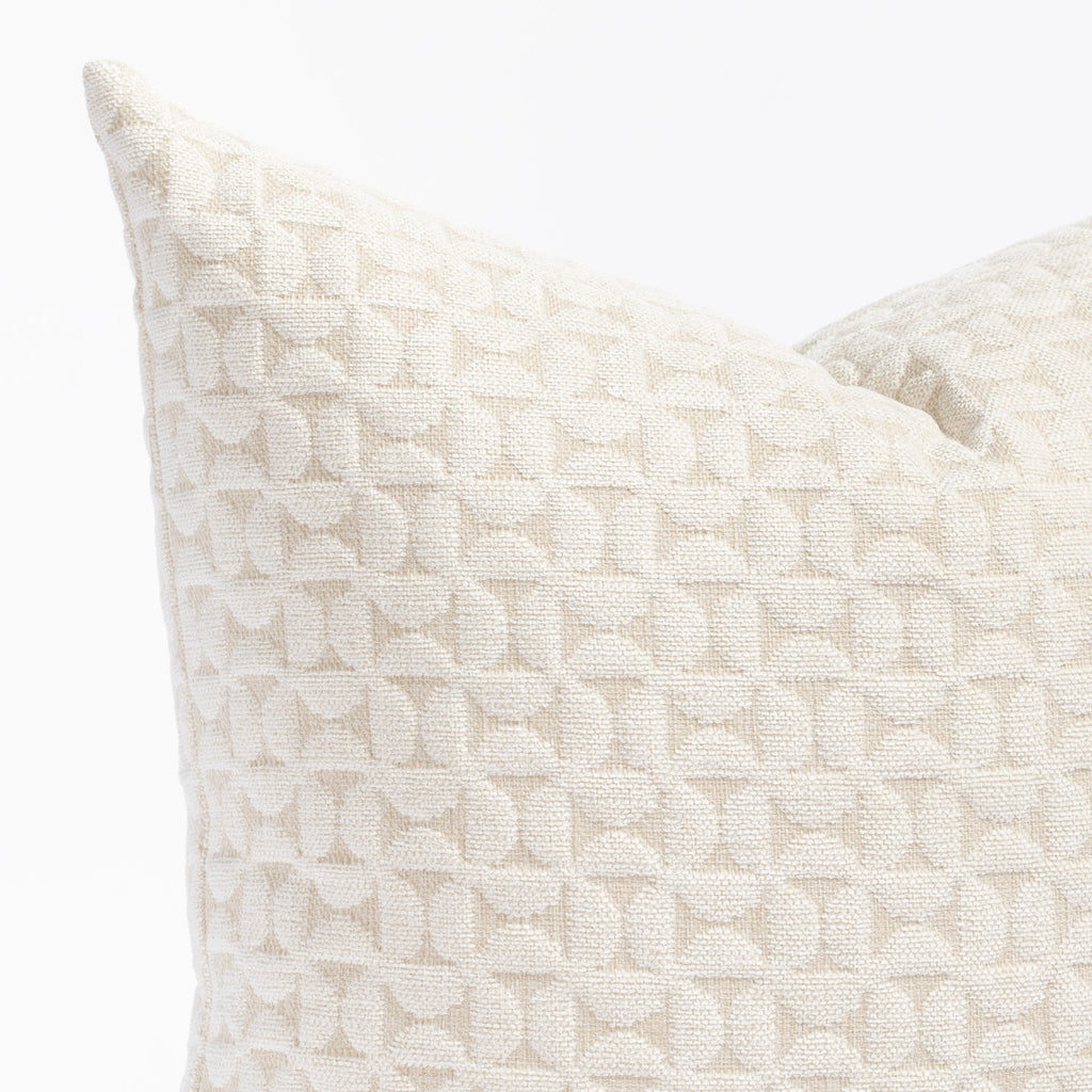 a plush white geometric quilted patterned pillow : close up view