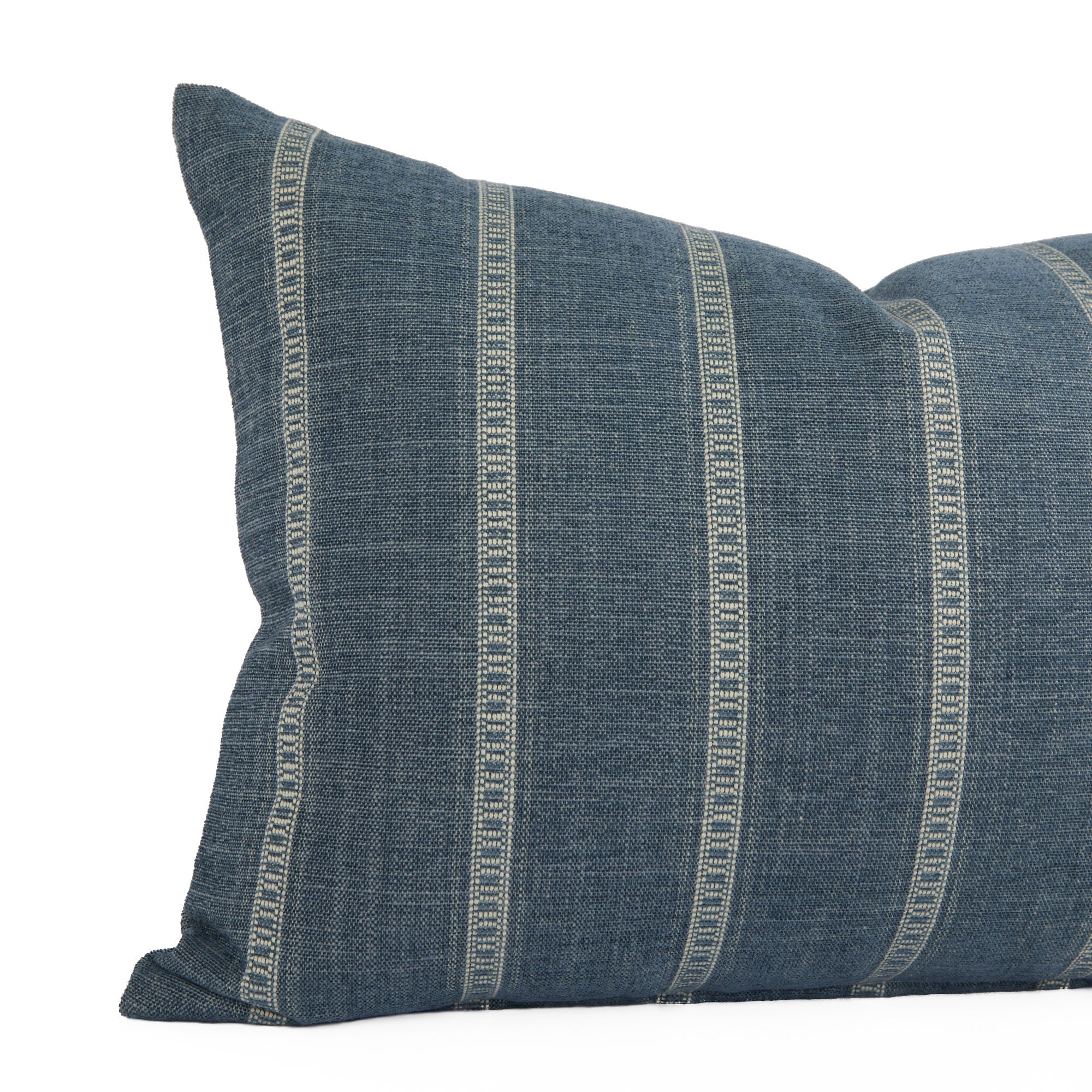 Close-up of Brunswick Stripe Chambray lumbar pillow by Tonic Living — vertical blue and white banded stripes with a soft, brushed texture.
