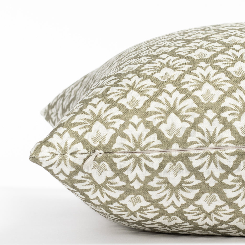 an olive green and cream floral block print throw pillow : close up zipper view
