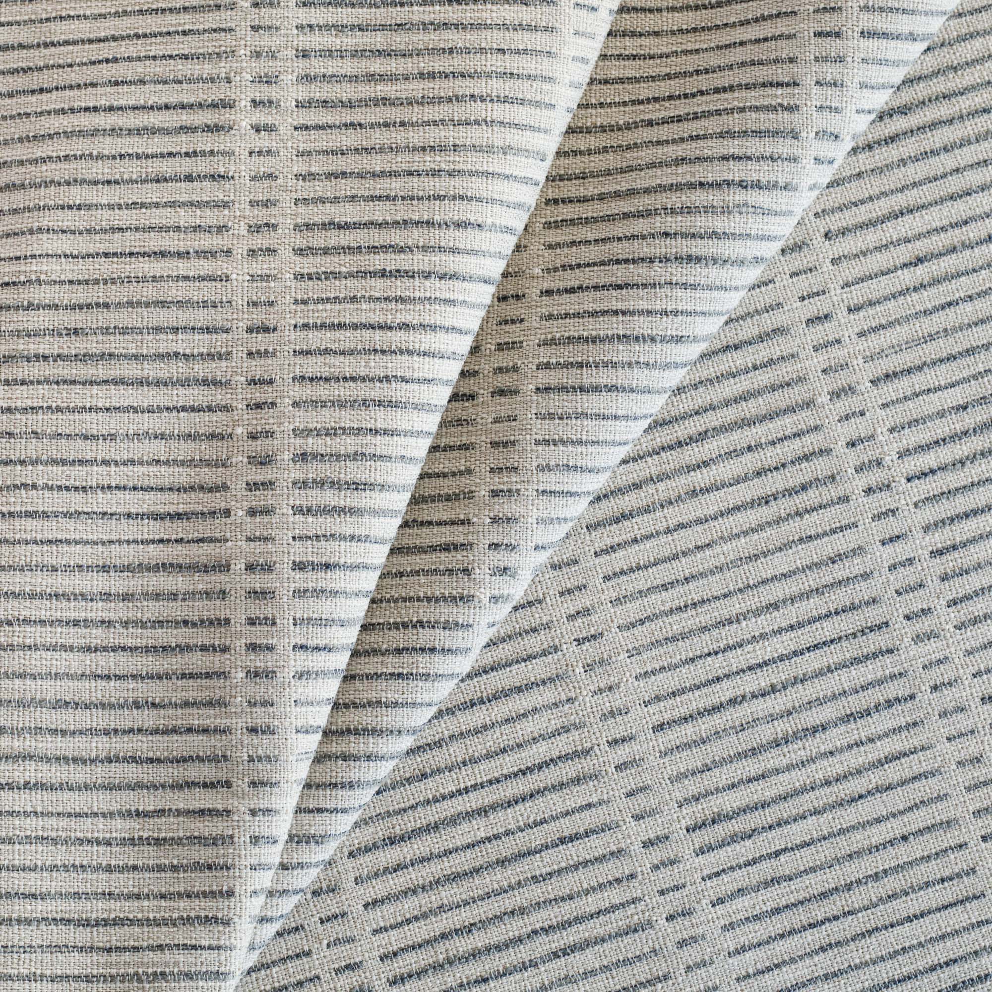Carson Stripe Stone Blue Fabric, a woven greige and blue dashed stripe patterned upholstery fabric from Tonic Living