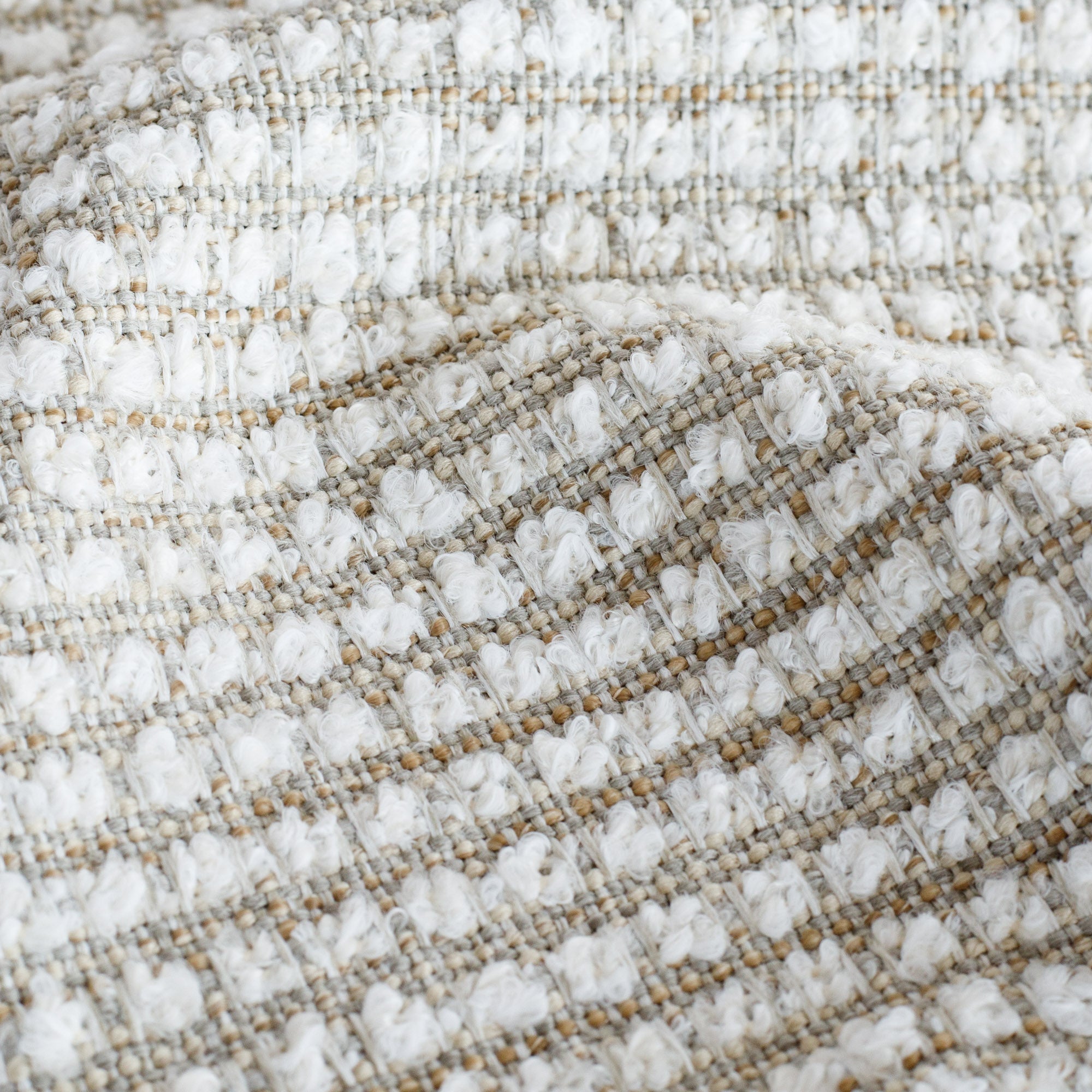 a wheat beige and white nubby textured high performance upholstery fabric : close up view