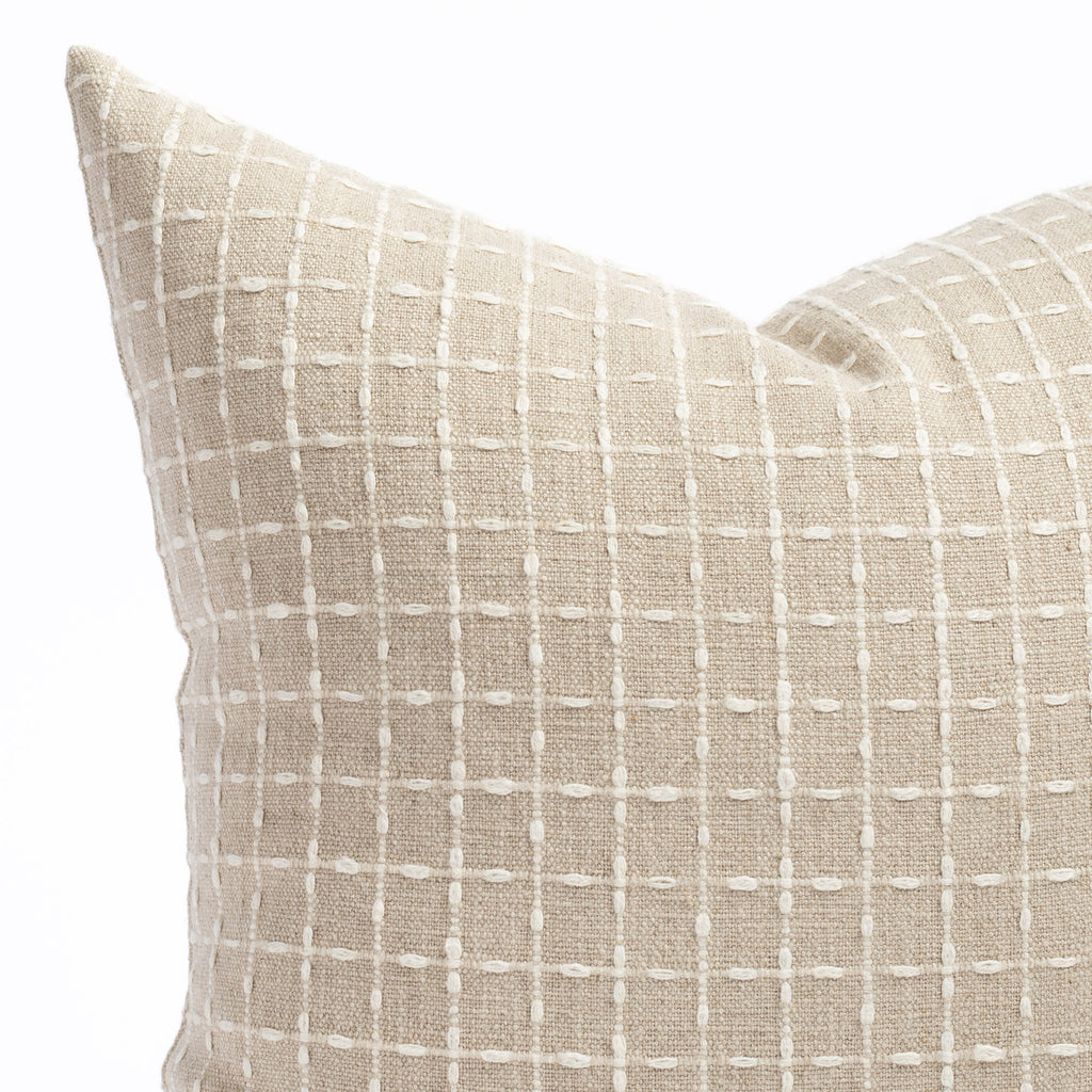 a beige flax with cream stitched windowpane patterned throw pillow: close up view