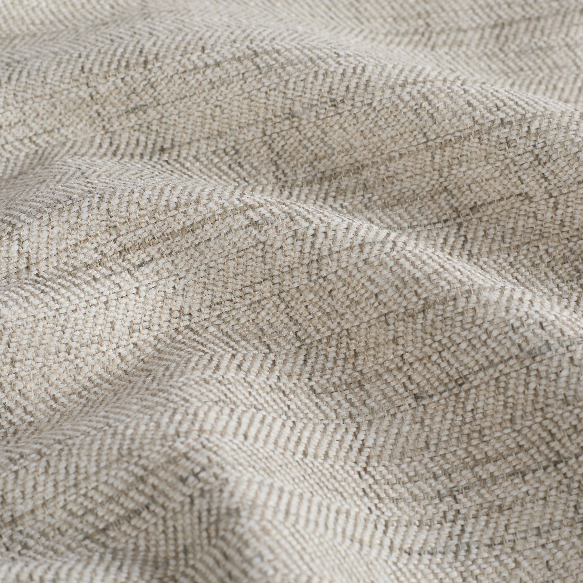 Close-up of Chester Pebble Fabric by Tonic Living – soft multi-tonal herringbone upholstery material.