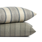 Stack of Tonic Living Clark Stripe and Miller Stripe pillows featuring layered blue and neutral striped patterns.