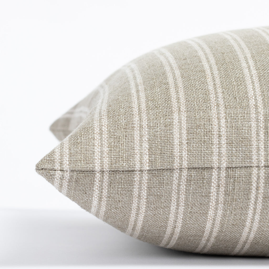 a dusty sage green and oatmeal beige vertical stripe throw pillow : close up side view