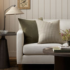 Tonic Living Conway Stripe sage throw pillow styled on a couch with the Florence Velvet Olive green cushion.