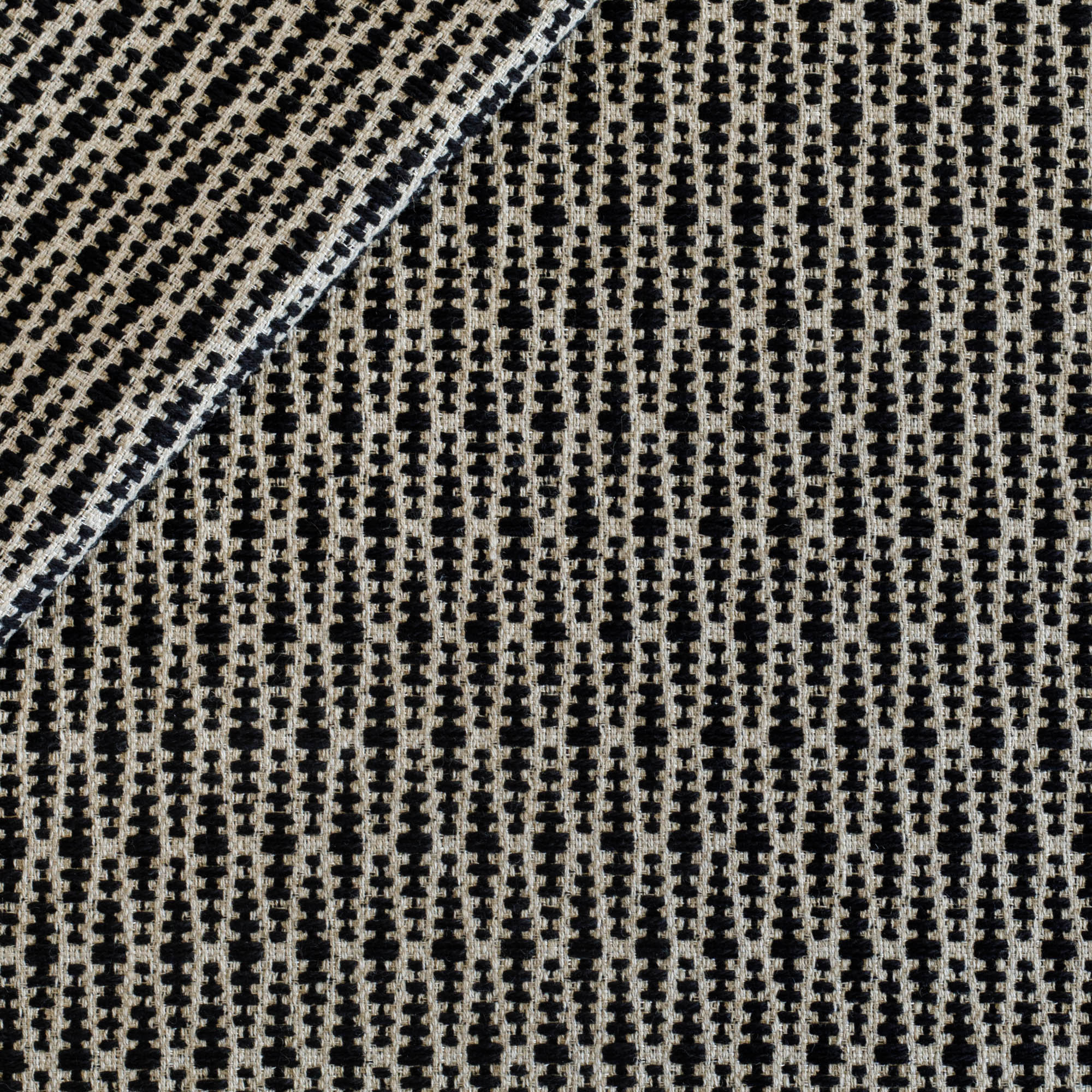 a black and tan textured geometric patterned upholstery fabric 