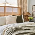 Bedford 22x22 moss green throw pillow styled on bed with Dash Stripe 22x22 cream & ochre from Tonic Living.