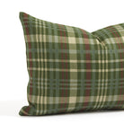 Close up of Tonic Living Dasher Holiday Lumbar Pillow showing a woven plaid pattern in pine green, burgundy, beige, and blue.