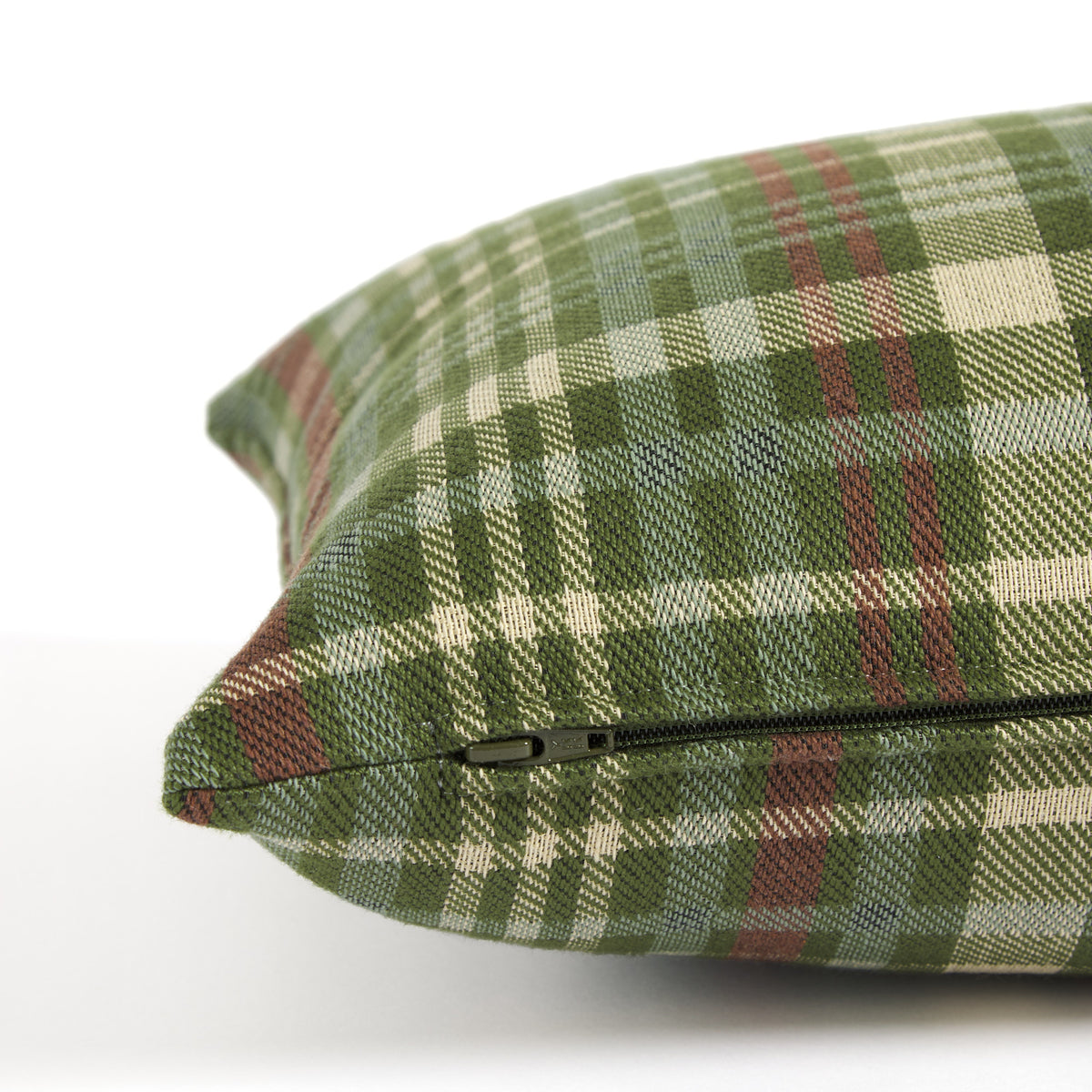 Side zipper detail of Tonic Living Dasher 14x20 Holiday Lumbar Pillow, a green plaid decorative cushion for Christmas decor.