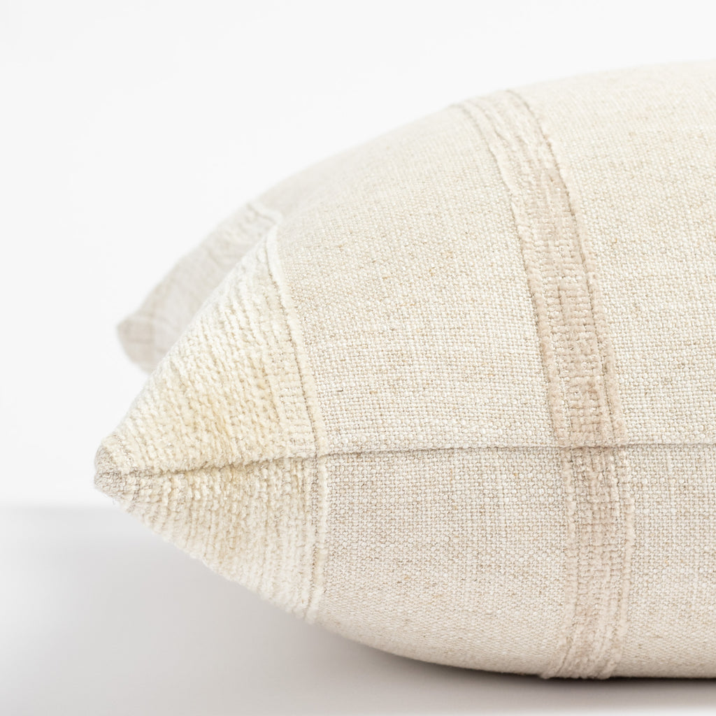 a neutral oatmeal beige tone on tone vertical chenille striped throw pillow: close up side view