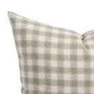 Close up of Tonic Living Emmett Plaid cushion showing its sage green and white gingham pattern.