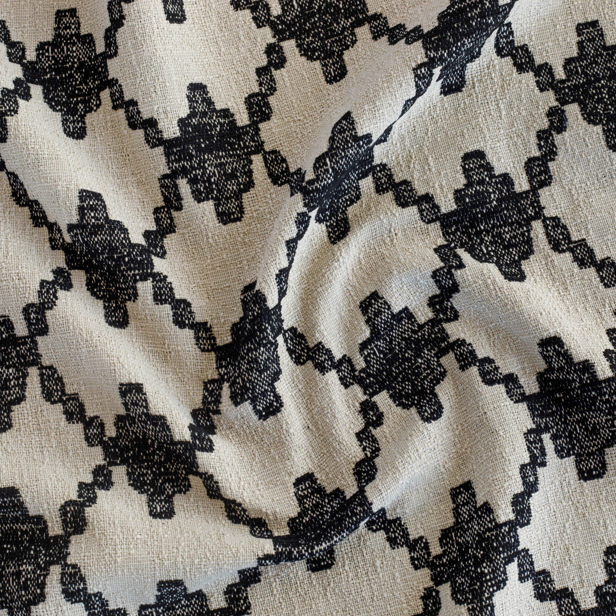 a black and natural abstract geometric patterned outdoor upholstery fabric from Tonic Living