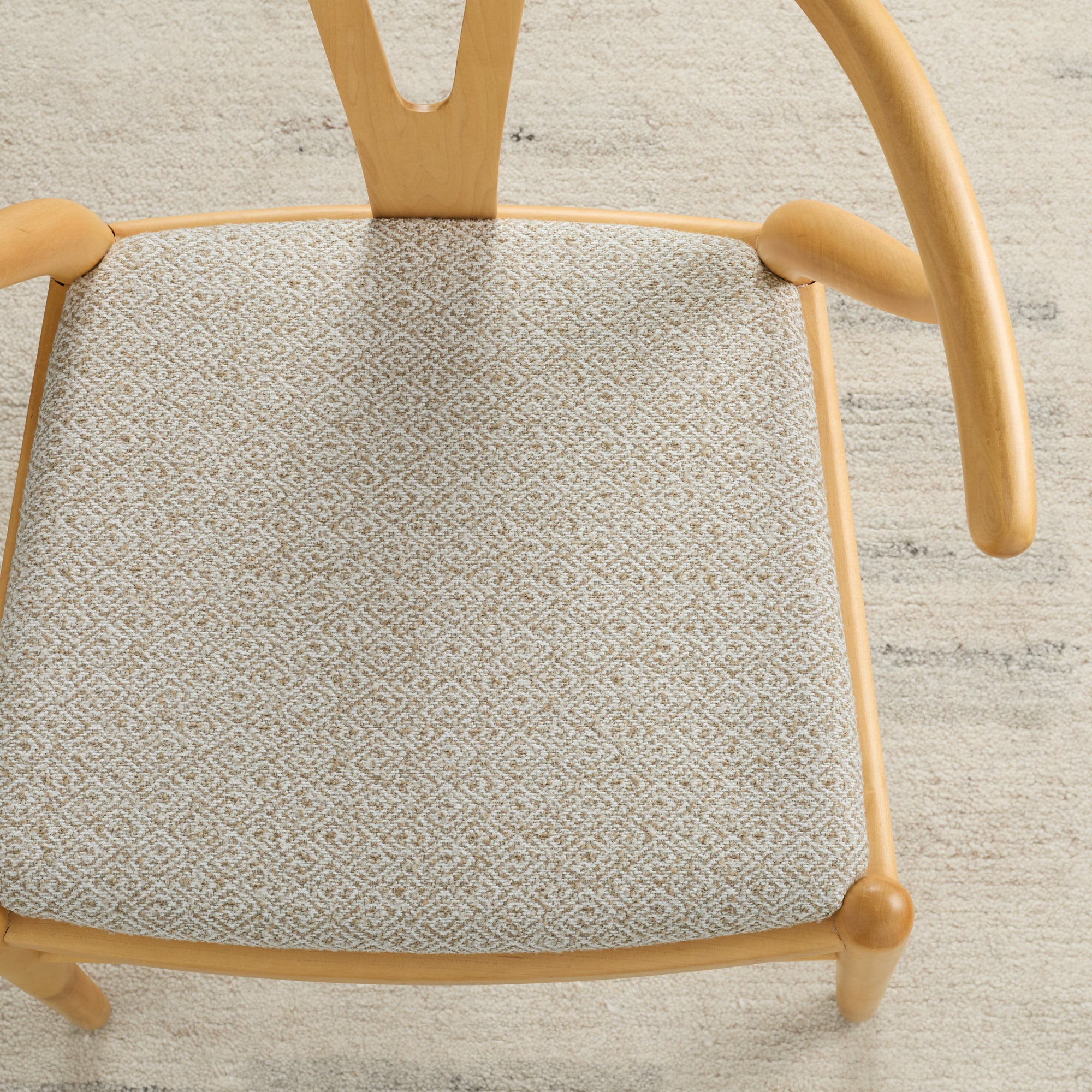 Warm beige Chester Wheat upholstery fabric by Tonic Living shown on a dining chair seat – durable and textural.