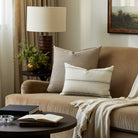 Tonic Living Crosby Stripe Truffle decorative pillow styled on a sofa with a neutral striped lumbar cushion.