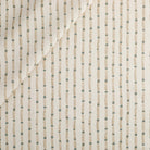 Tonic Living Hadley Stripe Fabric, an off-white, light brown, and blue drapery fabric with a bamboo-inspired stripe.