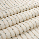 Tonic Living Hadley Stripe Fabric shown in soft folds like a Roman shade, featuring a blue and brown bamboo-inspired stripe.