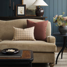 Tonic Living Hampton Burgundy decorative pillow styled on a sofa with Walker Plaid Camel lumbar cushion in a modern traditional living room.