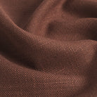 Close up of Tonic Living Hampton Burgundy upholstery fabric showing its earthy burgundy colour, subtle brown undertones, and linen-like woven texture.