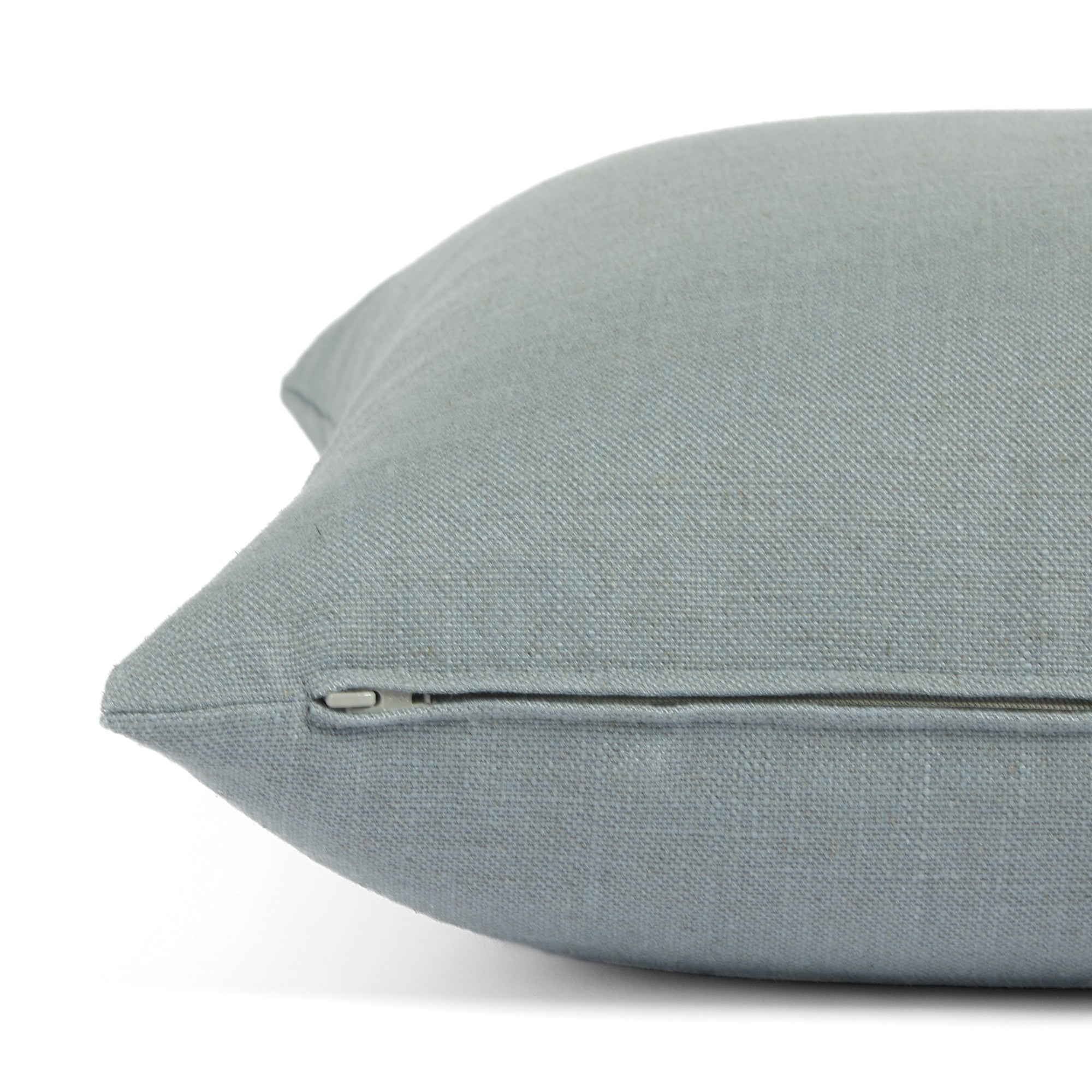 Side zipper detail of Tonic Living Hampton 22x22 throw pillow in soft chambray blue.