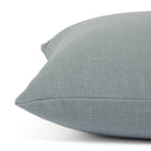 Side view of Tonic Living Hampton Chambray decorative pillow highlighting its light blue Belgian linen look.