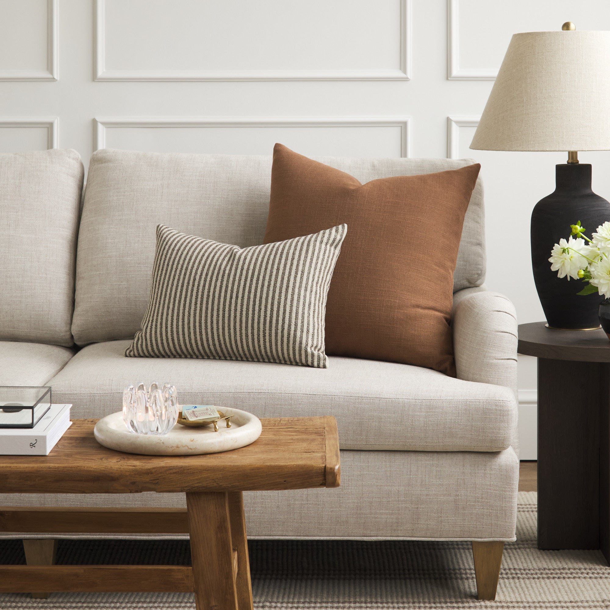 Tonic Living Hampton Cinnamon brown decorative pillow styled on a sofa with a neutral Crosby Stripe lumbar cushion.