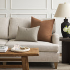Tonic Living Hampton Cinnamon brown decorative pillow styled on a sofa with a neutral Crosby Stripe lumbar cushion.