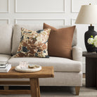 Tonic Living Hampton Cinnamon brown cushion styled on a sofa with Marbella Inkwell abstract floral pillow.