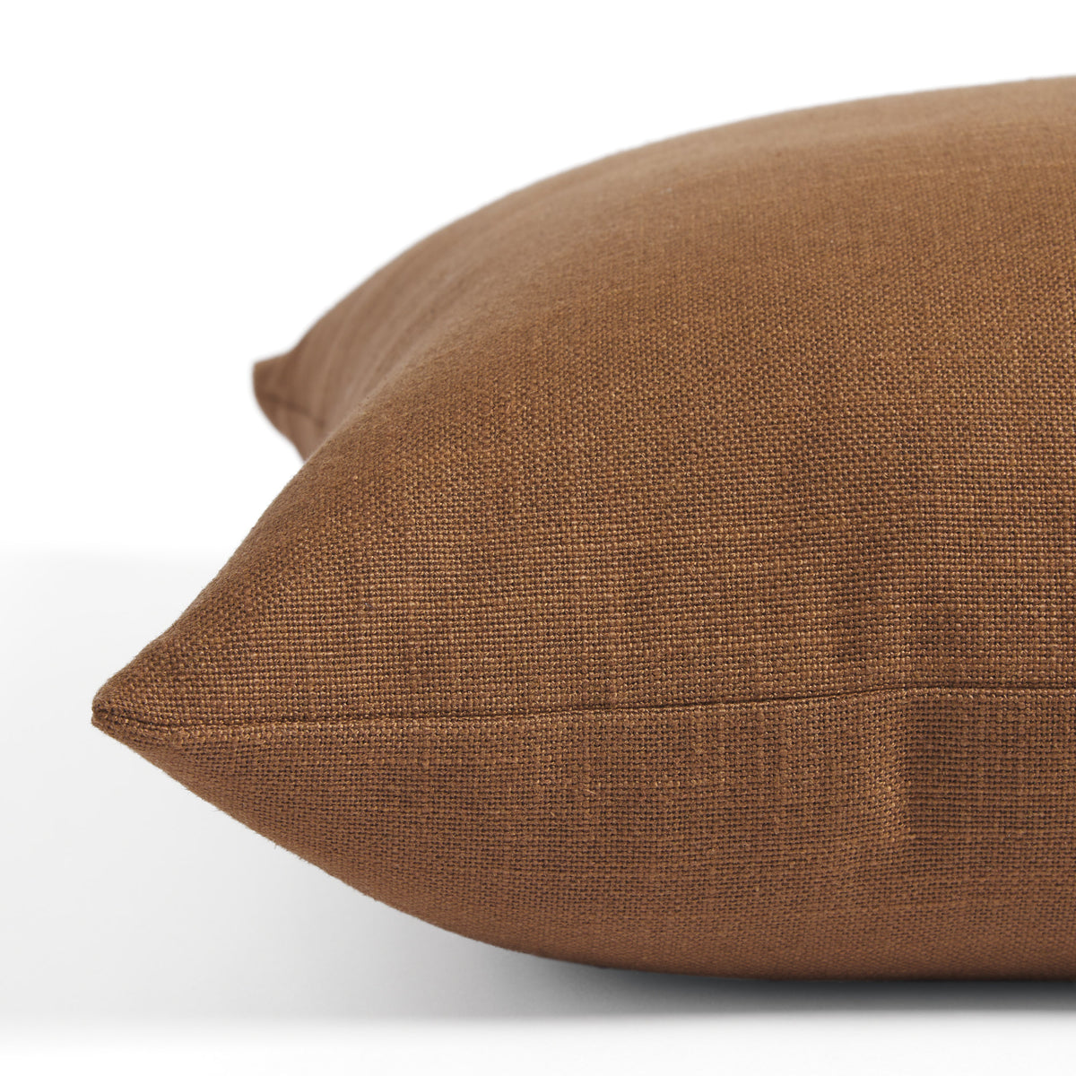 Side view of Tonic Living Hampton Cinnamon toss cushion highlighting its rich russet brown colour and linen-look texture.