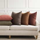 Tonic Living Hampton pillow collection styled on a sofa, featuring linen-look throw pillows in a range of rich earthy colours.