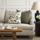 Tonic Living Hampton Moss green cushion styled on a sofa with Paloma Olive floral throw pillow.