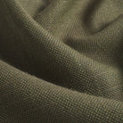 Close up of Tonic Living Hampton Moss upholstery fabric showing its earthy green colour, moss tones, and linen-like woven texture.
