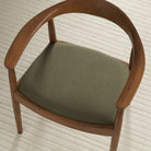 Tonic Living Hampton Moss high-performance upholstery fabric shown on a dining chair seat in a rich moss green.