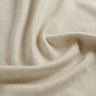 Tonic Living Hampton Oatmeal performance fabric shown with movement highlighting its soft linen-like texture.