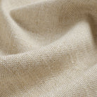 Close up of Tonic Living Hampton Oatmeal fabric showing textured beige weave with a linen-inspired finish.