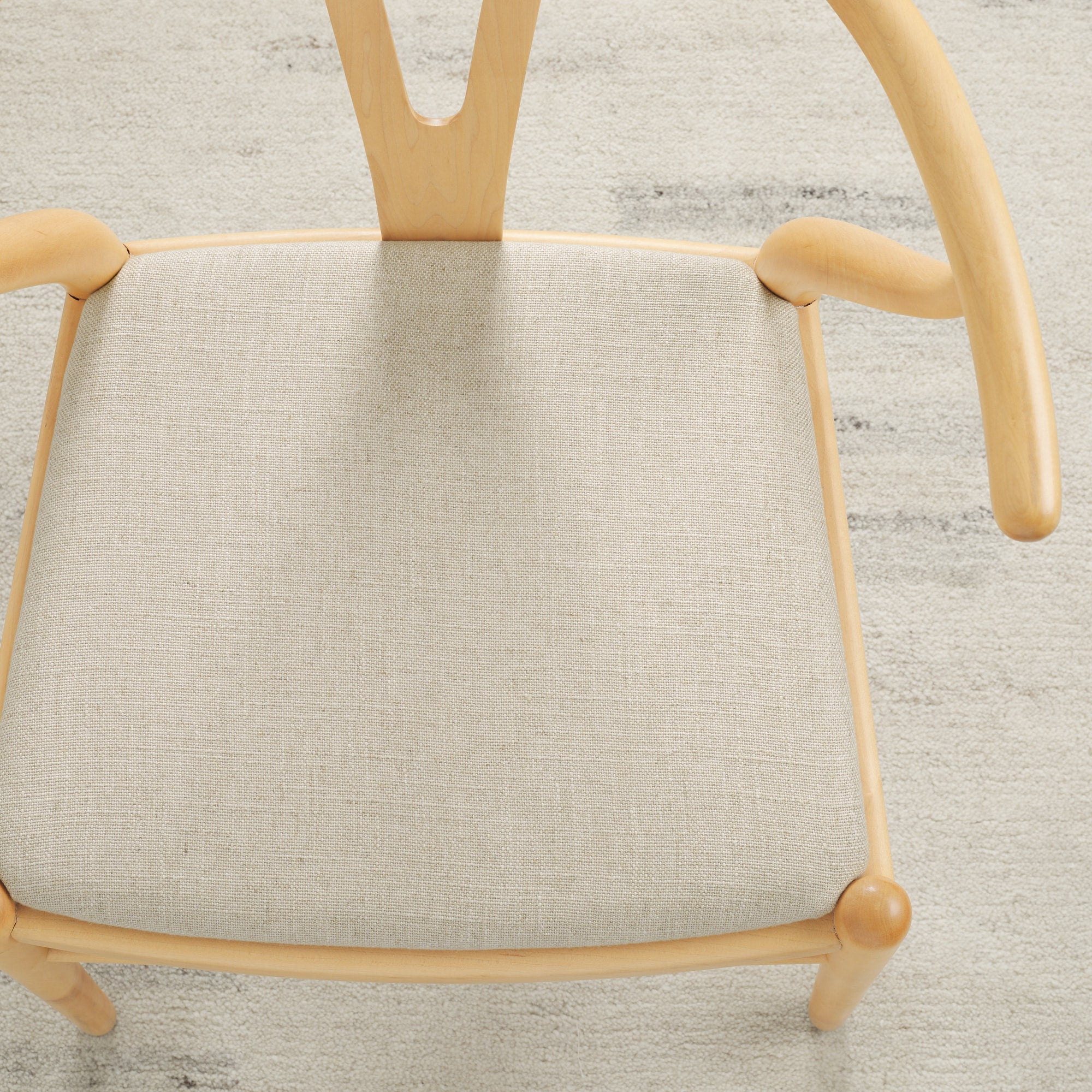 Tonic Living Hampton Oatmeal high-performance upholstery fabric on a dining chair seat in soft beige linen-look texture.