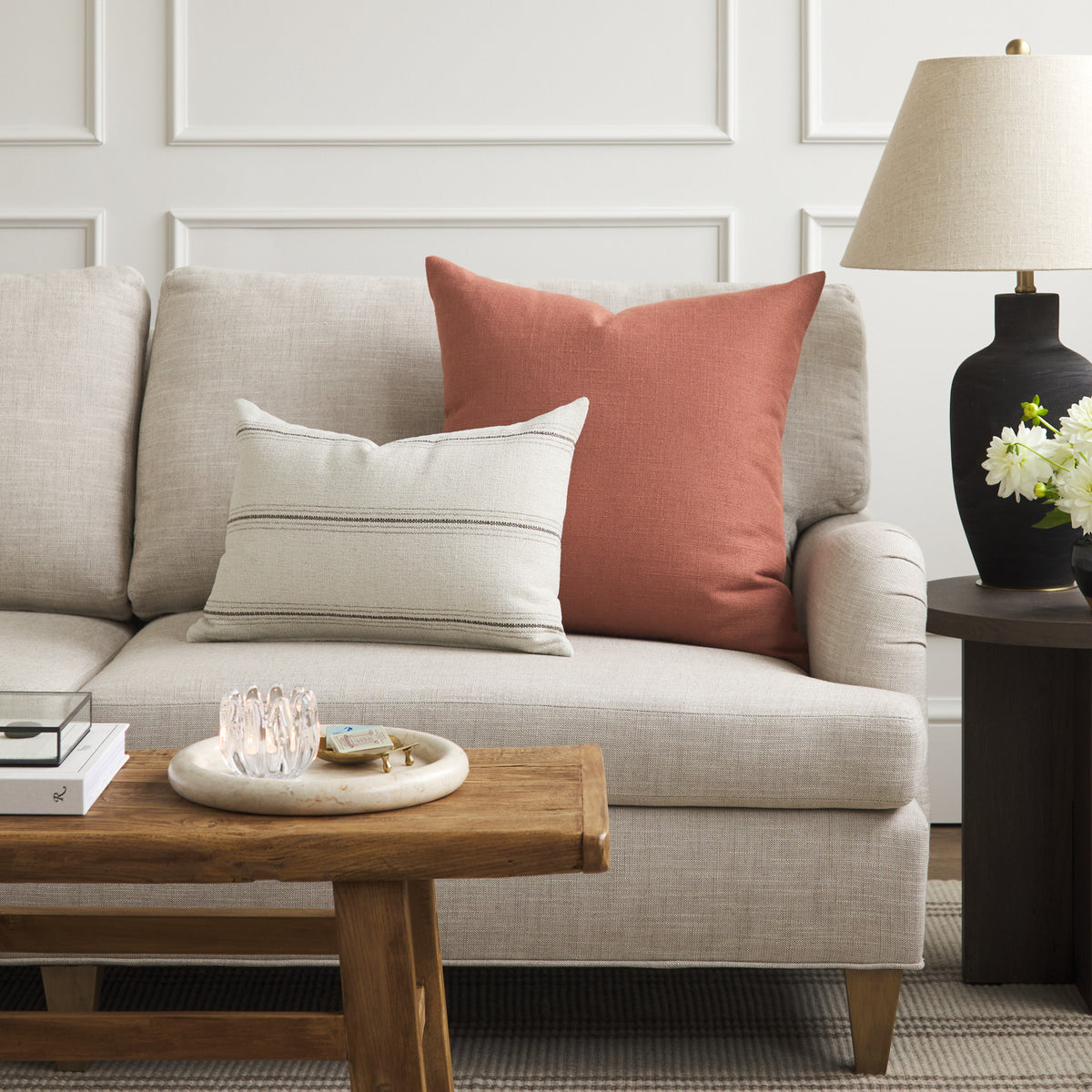 Tonic Living Hampton Rosewood decorative pillow styled on a sofa with a neutral beige and brown Gibson Stripe lumbar cushion.