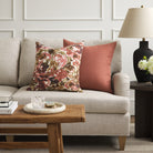 Tonic Living Hampton Rosewood pink terracotta cushion styled on a sofa with Marbella Rose abstract floral pillow.