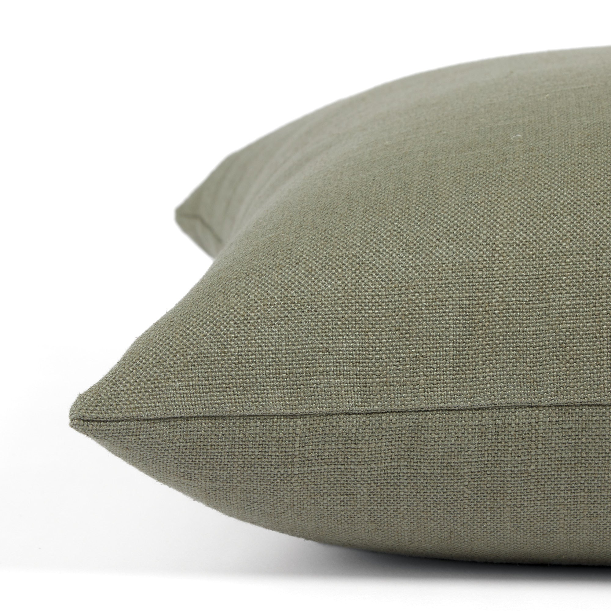 Side view of Tonic Living Hampton Sage decorative pillow highlighting its earthy green Belgian linen look.