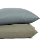 Stack of Tonic Living Hampton 24x24 pillows in Sage and Chambray featuring soft linen-look texture.