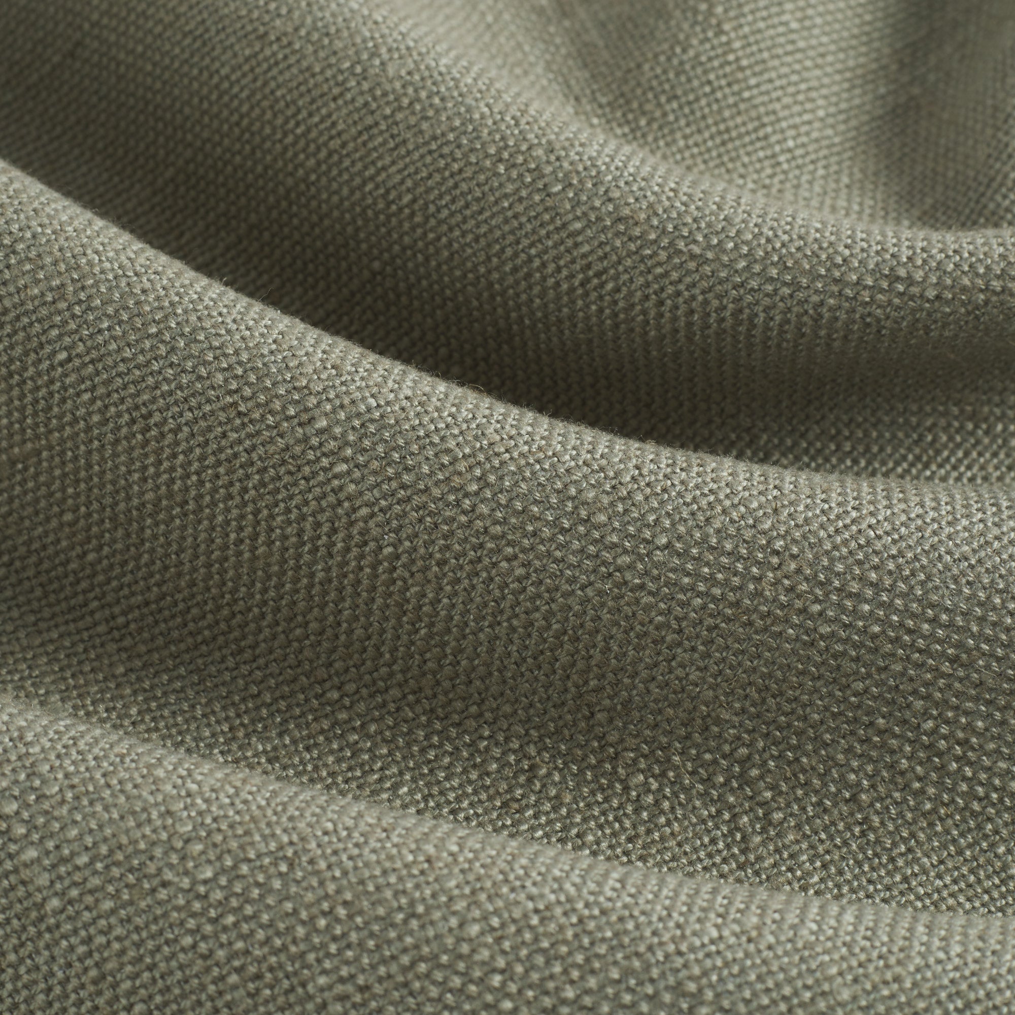 Close up of Tonic Living Hampton Sage fabric showing textured green weave with a linen-inspired finish.