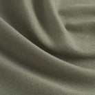 Tonic Living Hampton Sage performance fabric shown with movement highlighting its soft linen-like texture.