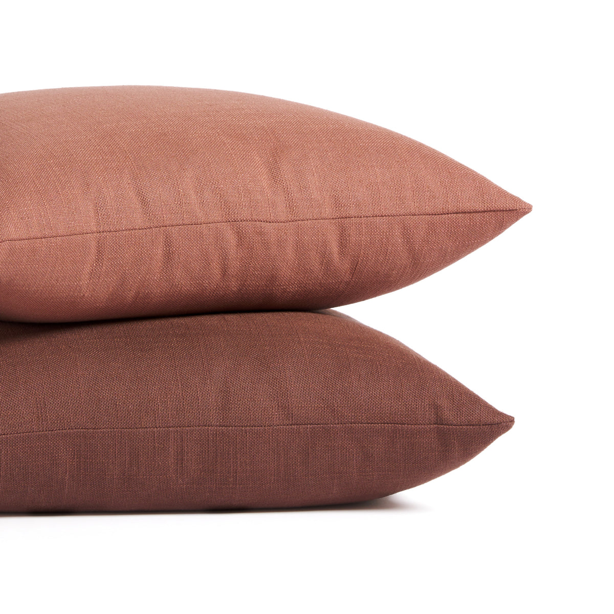 Stack of Tonic Living Hampton pillows in Rosewood earthy pink and Burgundy deep red-brown with linen-inspired texture.